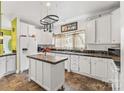 Bright kitchen with an island, white cabinetry, contrasting countertops and modern appliances at 3951 Springs Rd, Conover, NC 28613