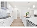 Bright, modern kitchen with white cabinets, sleek countertops, stainless steel appliances, and decorative backsplash at 2627 Ashbourne Dr, Gastonia, NC 28056