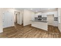 Modern kitchen featuring white cabinets, granite countertops, stainless steel appliances, and hardwood floors at 4120 Village Nw Blvd, Conover, NC 28613