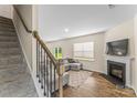 Bright living room with fireplace, hardwood floors, and stairs leading to upper level at 4120 Village Nw Blvd, Conover, NC 28613
