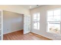 Office space features neutral walls, wood-look floors, and large windows providing lots of natural light at 2054 Van Buren Rd, Sherrills Ford, NC 28673