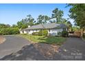 White brick ranch home with a long driveway and gated entrance at 1626 S Wendover Rd, Charlotte, NC 28211