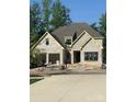Newly built two-story brick home with a two-car garage on a sunny day at 1211 Royal Prince Ct, Charlotte, NC 28211