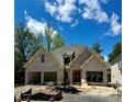 New two-story brick home with a two-car garage and beautiful blue skies at 1211 Royal Prince Ct, Charlotte, NC 28211