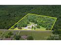 Aerial view of property showcasing lush landscaping and mature trees on a spacious lot at 12770 Bringle Ferry Rd, Richfield, NC 28137