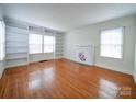 Spacious living room with hardwood floors, built-in shelves, and fireplace at 705 Neil St, Gastonia, NC 28052