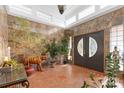 Grand foyer with stone walls, tile floors, clerestory windows, and double entry doors at 640 Davie Ave, Statesville, NC 28677