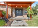 Charming front porch with brick accents, double doors with round glass, and potted plants at 640 Davie Ave, Statesville, NC 28677
