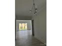 Bright living room featuring hardwood floors, recessed lighting, and large windows for ample natural light at 5209 Mint Harbor Way # 0352, Charlotte, NC 28269
