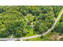 Aerial view of a house on a wooded lot near a curving road at 7507 Waxhaw Creek Rd, Waxhaw, NC 28173