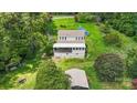 Aerial view of a house with detached workshop and solar panels, nestled in a wooded area at 7507 Waxhaw Creek Rd, Waxhaw, NC 28173
