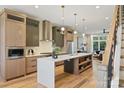 Spacious kitchen with island, stainless steel appliances, and light wood cabinets at 112 Frazier Ave, Charlotte, NC 28216