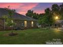 Brick home with a large backyard at dusk at 6801 Cinnamon Cir, Mint Hill, NC 28227