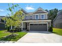 Charming two-story house boasting a gray exterior, well-manicured lawn, and a spacious two-car garage at 2024 Cedar Falls Dr # 9, Waxhaw, NC 28173