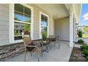 Cozy front porch showcasing stylish chairs, decorative plants, and neutral-toned exterior at 2024 Cedar Falls Dr # 9, Waxhaw, NC 28173