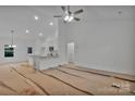 Expansive living room with bright white walls and a ceiling fan, awaiting its final touches for a modern feel at 6187 Long Branch Rd, Salisbury, NC 28147