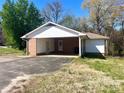 Spacious carport providing covered parking and convenient access to the home's side entrance at 2310 Montford Nw Ave, Concord, NC 28027