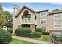 Exterior view of condo building with landscaping at 5003 Sharon Rd # L, Charlotte, NC 28210