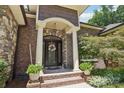 Inviting exterior with brick facade and a charming front porch at 120 Holly Branch Ln, Troutman, NC 28166