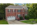 Brick two-story house with a two-car garage and landscaped yard at 5267 Norway Ln, Rock Hill, SC 29732