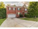 Two-story brick home with a large driveway and mature trees at 5267 Norway Ln, Rock Hill, SC 29732
