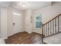 Bright entryway with hardwood floors, staircase, and coat closet at 8053 Cornhill Ave, Charlotte, NC 28277