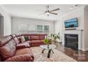 Spacious living room with a fireplace and leather sectional at 4043 Orchid Way, Tega Cay, SC 29708