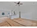 Bright living room featuring high ceilings with fan, open floor plan, and unfinished flooring at 6217 Long Branch Rd, Salisbury, NC 28147