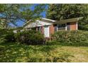 Brick home with dark shutters, grassy front yard, and covered front entry steps at 2001 Mcdonald Dr, Charlotte, NC 28216