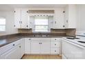 Bright kitchen featuring white cabinets, a double sink, and tile countertops at 2001 Mcdonald Dr, Charlotte, NC 28216