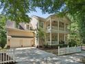 Charming two-story home with a double porch, a white picket fence, and a long driveway at 927 Dericks Xing, Fort Mill, SC 29708