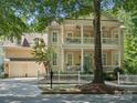 Charming two-story home with a double porch, a white picket fence, and an attached two car garage at 927 Dericks Xing, Fort Mill, SC 29708