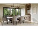 Elegant dining room with large windows and a statement chandelier at 626 Concord Rd, Davidson, NC 28036