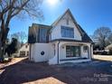 New construction home featuring white painted brick, arched entry, and a separate two car garage at 626 Concord Rd, Davidson, NC 28036