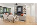 Cozy living room featuring a fireplace with dark wood surround and sliding glass doors at 626 Concord Rd, Davidson, NC 28036