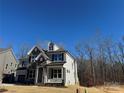 Two-story house with stone and siding accents and a metal roof at 5031 Mclaughlin Loop # 60, Waxhaw, NC 28173