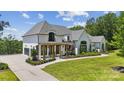 Beautiful modern home with manicured lawn and a lovely pergola entryway at 18304 Rosapenny Rd, Charlotte, NC 28278