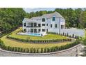 Stunning backyard showcasing a modern pool, covered patio, and beautifully landscaped garden at 18304 Rosapenny Rd, Charlotte, NC 28278