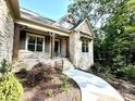 Inviting stone-accented front porch with wood supports and landscaped garden leading to the entrance at 859 Tamary Way # 34, Landis, NC 28088