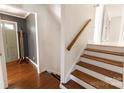 Bright foyer features hardwood floors, stairs, and a gray accent wall at 1628 Shannonhouse Dr, Charlotte, NC 28215