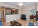 Open living room with hardwood floors, ceiling fan, and view into kitchen at 1320 Fillmore Ave # 311, Charlotte, NC 28203
