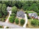 Aerial view of a beautiful home nestled among lush trees, showcasing the home's setting and curb appeal at 7582 Cottonwood Dr # 39, Denver, NC 28037