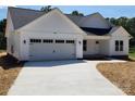Charming single-story home with a two-car garage, manicured lawn, and modern white siding at 9609 Stokes Ferry Rd, Gold Hill, NC 28071