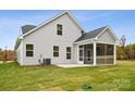 House exterior showcasing a screened porch and grassy backyard at 8336 Acadia Pkwy, Sherrills Ford, NC 28673