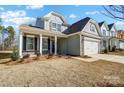 Two-story craftsman style home with gray siding, stone accents, and a two-car garage at 5308 Verona Rd # 75, Charlotte, NC 28213