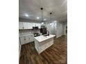 Kitchen features white cabinets, stainless steel appliances, a center island and wood floors at 1137 6Th St, Lancaster, SC 29720