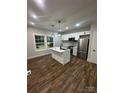 Bright kitchen features white cabinets, stainless appliances, and center island with pendant lighting at 1137 6Th St, Lancaster, SC 29720