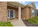 Inviting front porch with brick columns and stone walkway at 108 Fleming Dr, Statesville, NC 28677