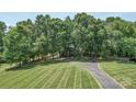 Expansive lawn with a long driveway leading to a secluded home surrounded by lush trees and greenery at 3814 Watson Church Rd, Monroe, NC 28110