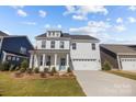 Beautiful two-story home featuring a bright blue front door and a two-car garage at 633 Amberjack Pl, York, SC 29745